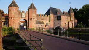 A large brick castle with a bridge leading to it