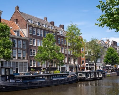 a canal with boats and buildings along it