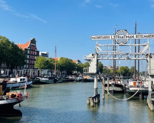 a waterway with boats and a sign for a restaurant